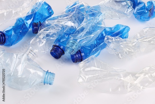 Crumpled disposable plastic bottles on white background