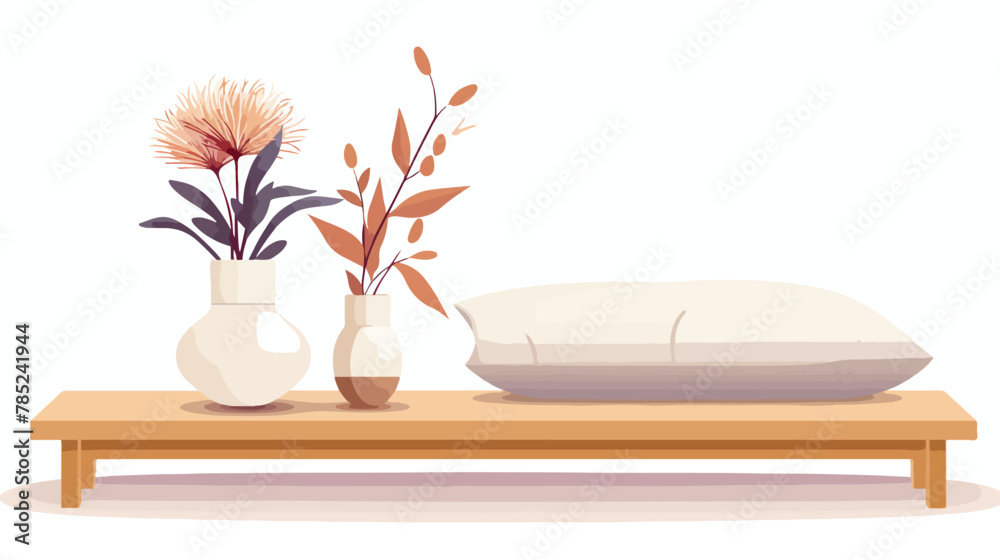 White vase holds dried flowers on small wooden table