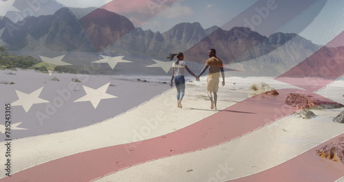 Image of american flag moving over couple holding hands and walking on beach