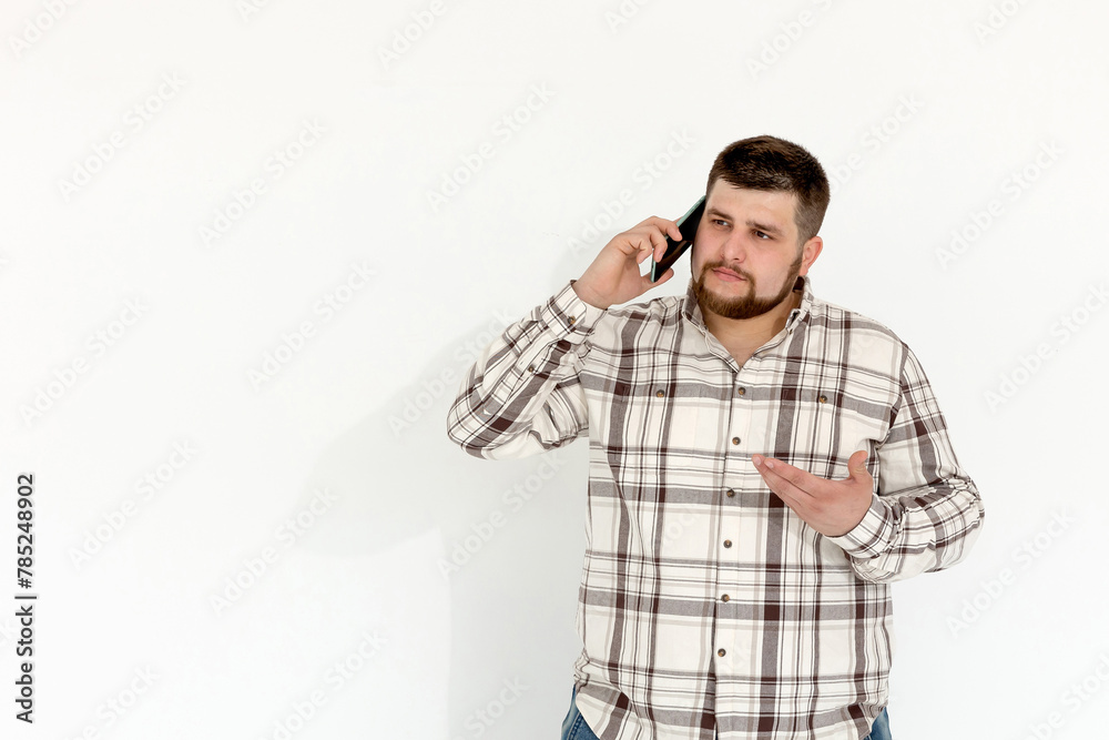 European fat emotional young man with phone on white background European fat emotional young man with phone on white background