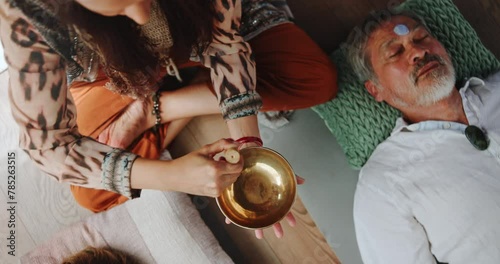 Person, hands and sound therapy with bowl above in peace, audio wave or vibration together. Top view or closeup of buddhist creating music for healing, culture or stress relief in treatment or mantra photo