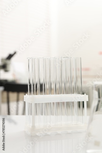 Laboratory analysis. Many test tubes on white table indoors © New Africa