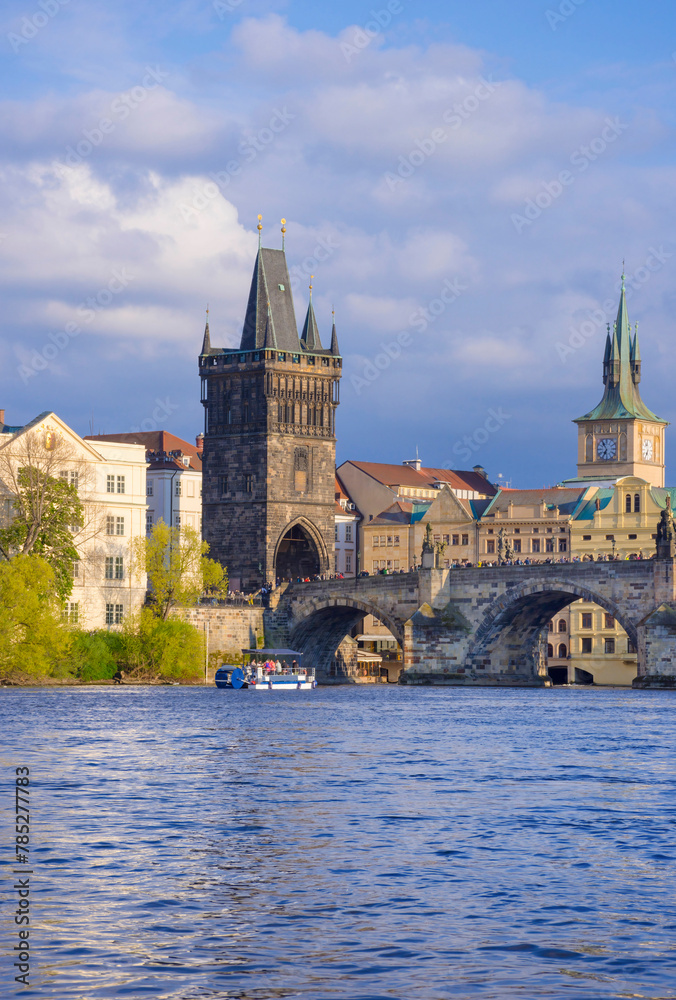 Charles Bridge (Karluv Most) on Vltava river and Old Town Bridge Tower, famous tourist destination in Prague, Czech Republic (Czechia), at sunset