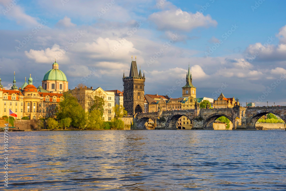 Charles Bridge (Karluv Most) on Vltava river and Old Town Bridge Tower, famous tourist destination in Prague, Czech Republic (Czechia), at sunset