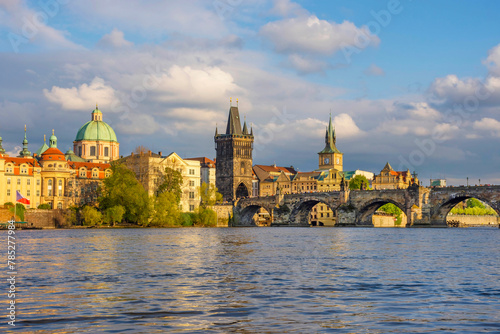 Charles Bridge (Karluv Most) on Vltava river and Old Town Bridge Tower, famous tourist destination in Prague, Czech Republic (Czechia), at sunset