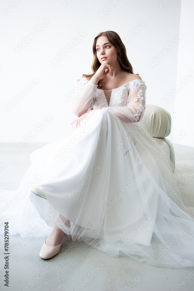 young beautiful woman in white wedding dress with long curly hair young beautiful woman in white wedding dress with long curly hair