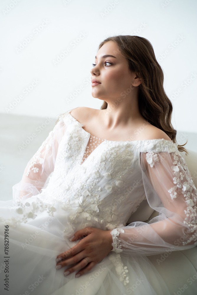 young beautiful woman in white wedding dress with long curly hair young beautiful woman in white wedding dress with long curly hair