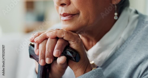 Senior woman, closeup and sad with cane for disability, healthcare and retirement in living room. Elderly person, walking stick and sigh on sofa for arthritis support, depression and mental health photo