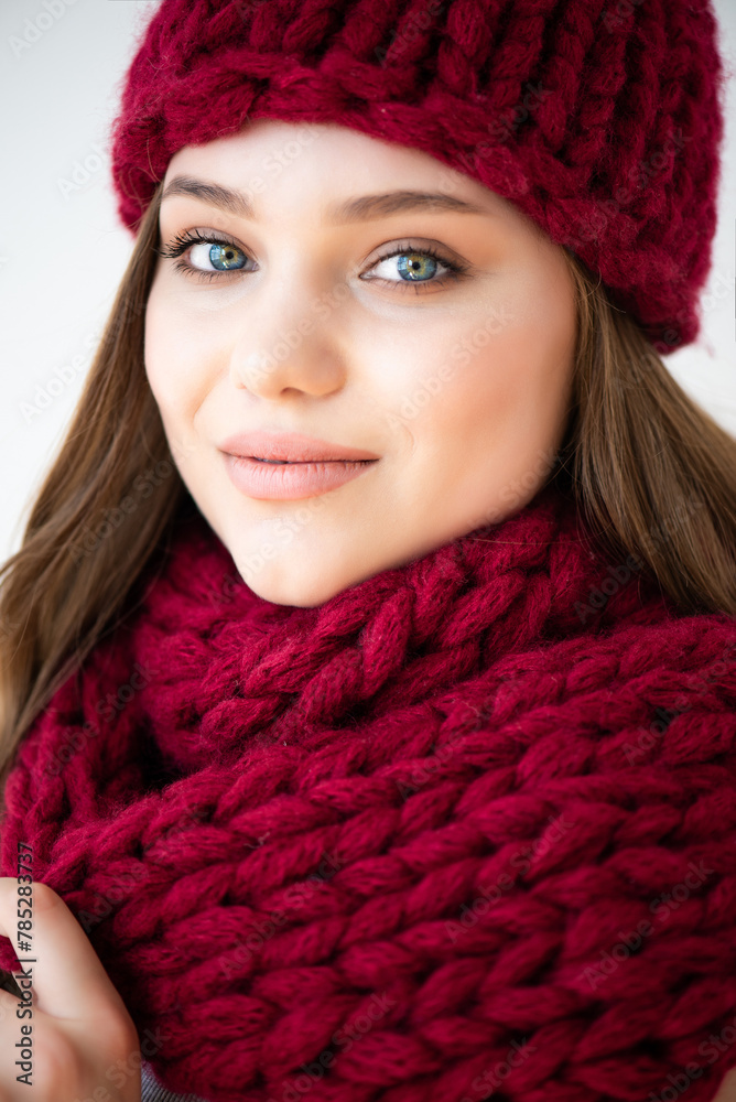 portrait of a beautiful young woman in a knitted hat and scarf portrait of a beautiful young woman in a knitted hat and scarf
