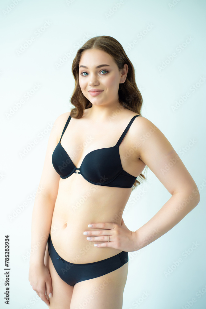 Fototapeta premium young woman with beautiful hair in black lingerie posing isolated on white background. Model test, snap, polaroid