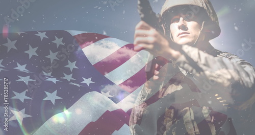 Image of snow falling over caucasian male soldier and flag of usa