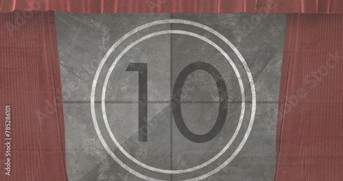 Image of movie vintage countdown in circle over brown curtains