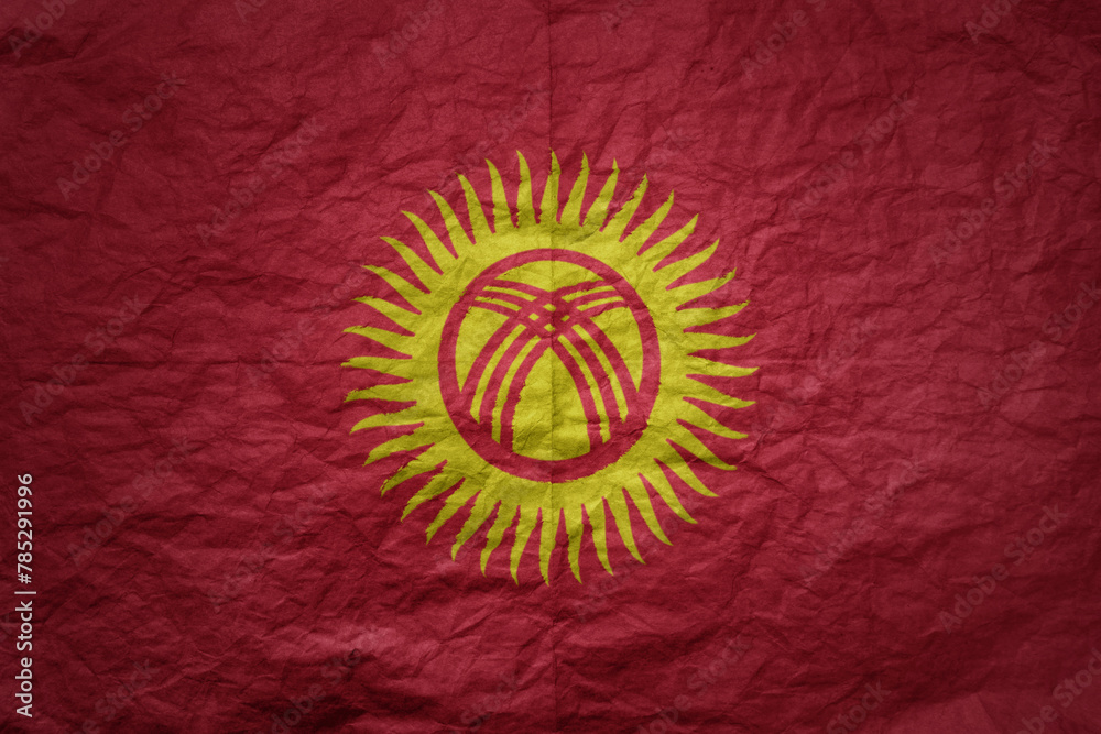 big national flag of kyrgyzstan on a grunge old paper texture background