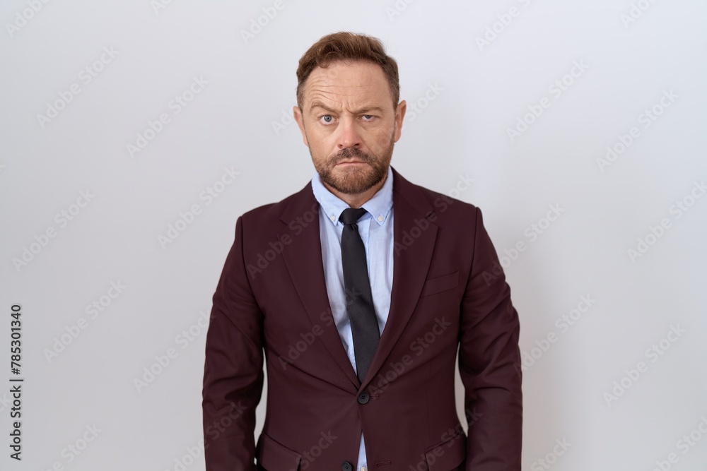 Middle age business man with beard wearing suit and tie skeptic and nervous, frowning upset because of problem. negative person.