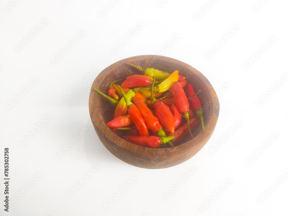 chilies in a small bowl on an isolated white background chilies in a small bowl on an isolated white background