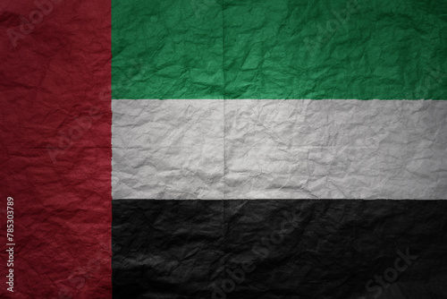 big national flag of united arab emirates on a grunge old paper texture background