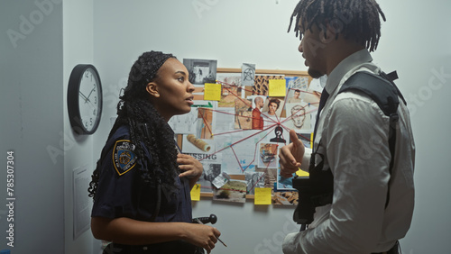A policewoman and investigator discuss a case in an office with a evidence board