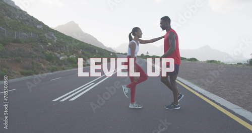 Image of the words level up written in white over couple exercising on mountain road