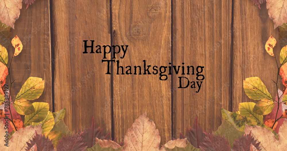 Obraz premium Image of happy thanksgiving day text over wooden background with autumn leaves