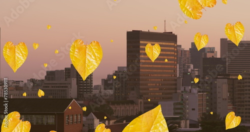 Image of orange autumn leaves falling over cityscape