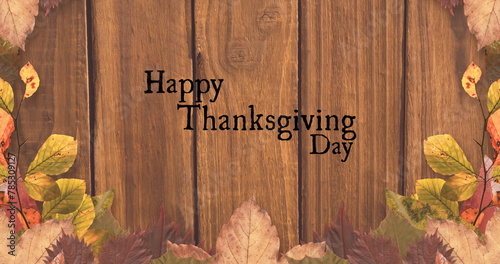 Image of happy thanksgiving day text over wooden background with autumn leaves