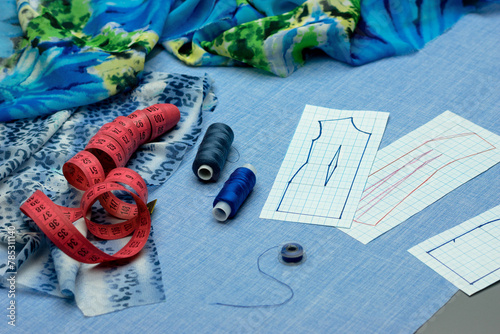 Sewing process. Fabric, patterns, accessories for sewing on the table close-up. Sewing and modeling of clothes.