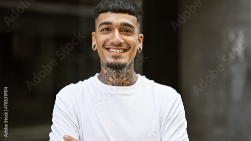 Φωτογραφία Portrait of a young, confident latin man, smiling with joy and standing on an ur