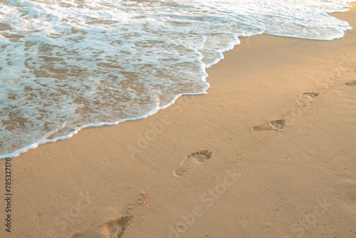 footprint of people on the sand of the sea with waves