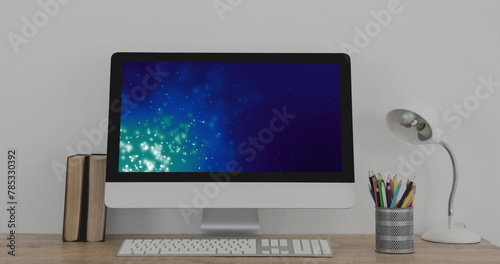 Image of laptop with light trails on screen on desk