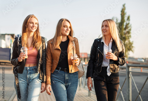 Young girlfriends walking on street together