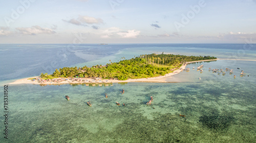 Aerial view of Maiga island panorama, beautiful blue lagoon and coral reef. photo