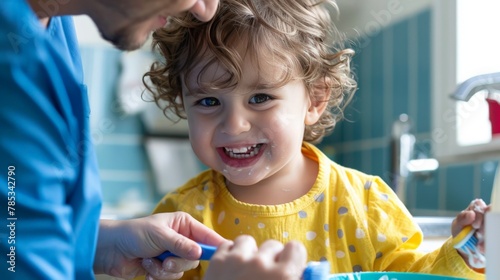 A child learning to brush teeth properly under parental supervision photo
