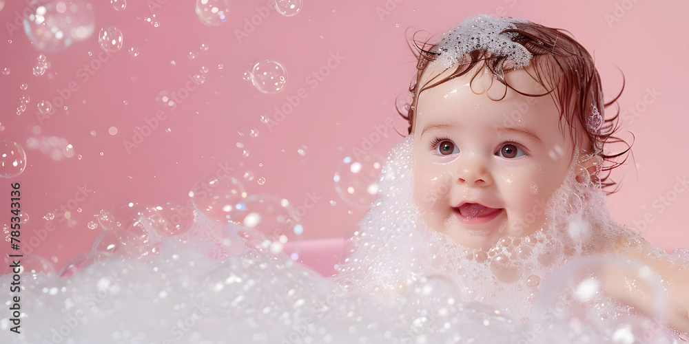 A small child in foam and soap bubbles on a pink backgrounds miling and laughing. A small child in foam and soap bubbles on a pink backgrounds miling and laughing.