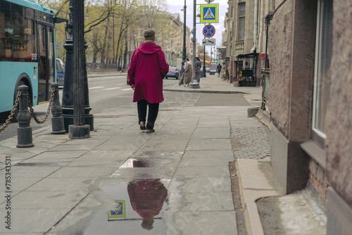 back view of senior woman walking alone along street of saint petersburg