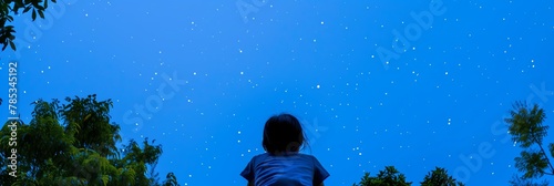 Child gazing up starry night sky wonder nature stars trees back view