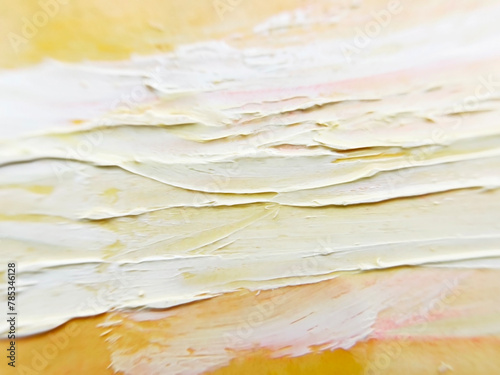 yellow ocher background of an artistic canvas with white impasto brush strokes of oil paint on it