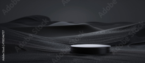 A dark podium in the center of an abstract black desert landscape, with a minimalist
