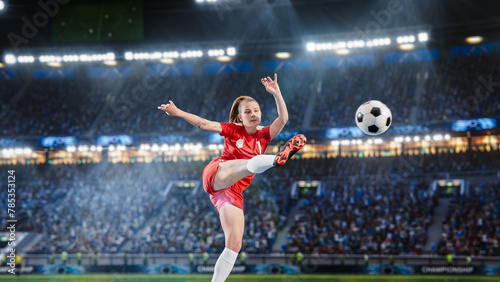 Aesthetic Shot Of Professional Female Soccer Football Player Jumping And Kicking A Ball on Stadium WIth Crowd Cheering. Winning Goal on International Championship Match on Arena Full Of Fans. © Gorodenkoff