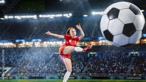 Aesthetic Shot Of Professional Female Soccer Football Player Jumping And Kicking A Ball on Stadium WIth Crowd Cheering. Goal on International Championship Match on Arena Full Of Fans. © Gorodenkoff