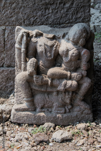 Lord Shiva and Parvati carved on a stone. Ruins of temple. Palasnath Temple. Temple is located in the backwater of Ujjani Dam. Palasdev, Pune, Maharashtra, India.