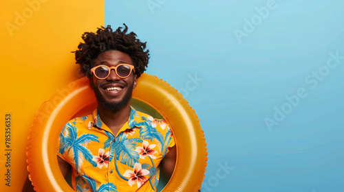 Smiling young man with sunglasses and Hawaiian shirt, ideal for holiday themes.