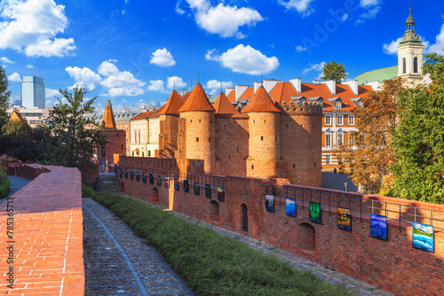 Cityscape with historic medieval fortification building Warsaw Barbican and Church of the Holy Spirit in Warsaw, Poland