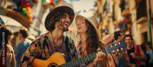 Happy hippie couple playing music and singing with friends in the street  having fun during outdoor party on a sunny day.
