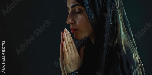 A muslim woman in Hijab praying. photo