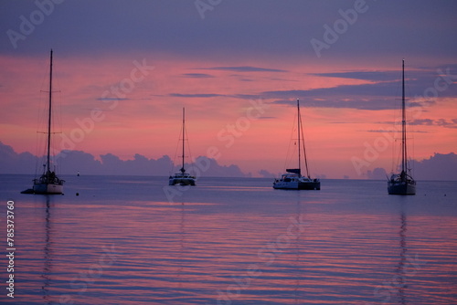 Some sailing boats at dusk, anchored on the lagoon. Rangiroa, Tuamotu archipelago, French Polynesia - November 10, 2022. photo