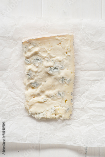 Slice of Lombard cheese, known as Stracchino or Gorgonzola. Italian food.