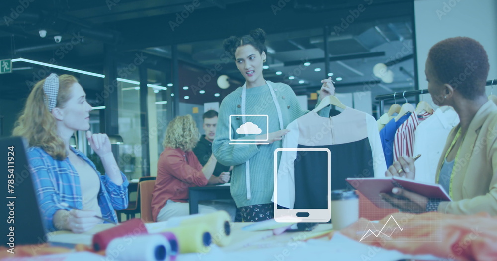 Obraz premium Image of application icons and graphs over diverse designer showing garment to coworkers