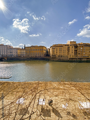 View from the Ponte Vecchio over the Arno river, in the ancient medieval city of Florence, Italy.