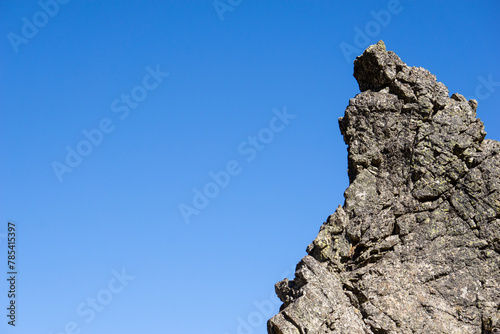 Peak rock in a blue sky background