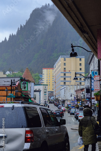 Fototapeta Naklejka Na Ścianę i Meble -  Grey, misty, foggy morning in Juneau Bay, Alaska with small islands channel cruising and houses, glacier mountains and low clouds downtown historic old town shopping district streets